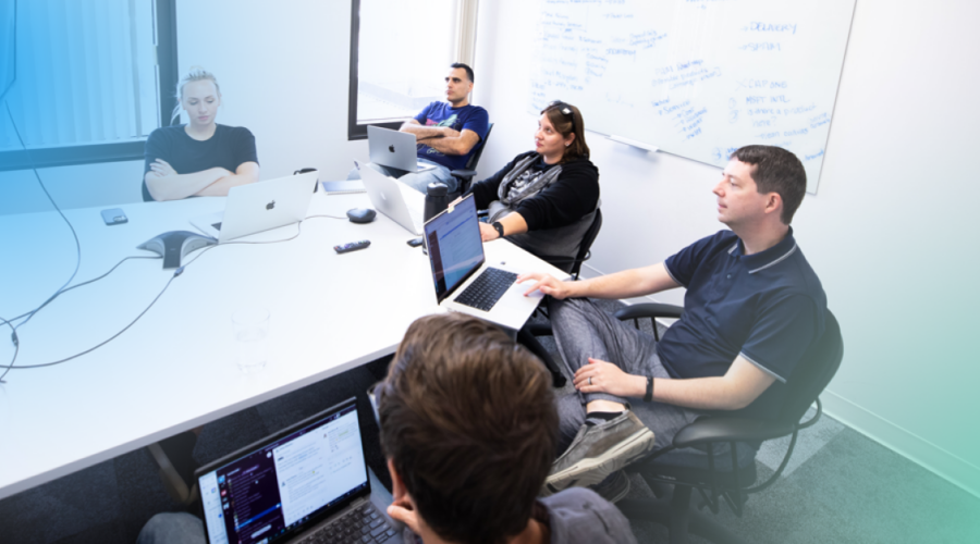 Photo of software engineers gathered around a conference table