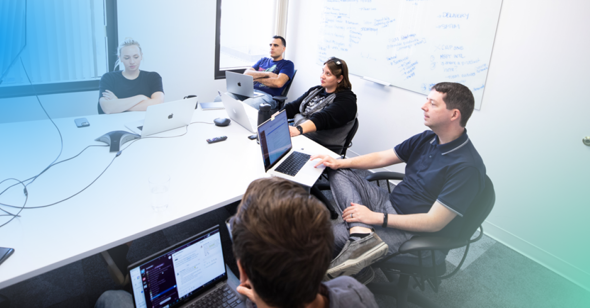 Photo of software engineers gathered around a conference table